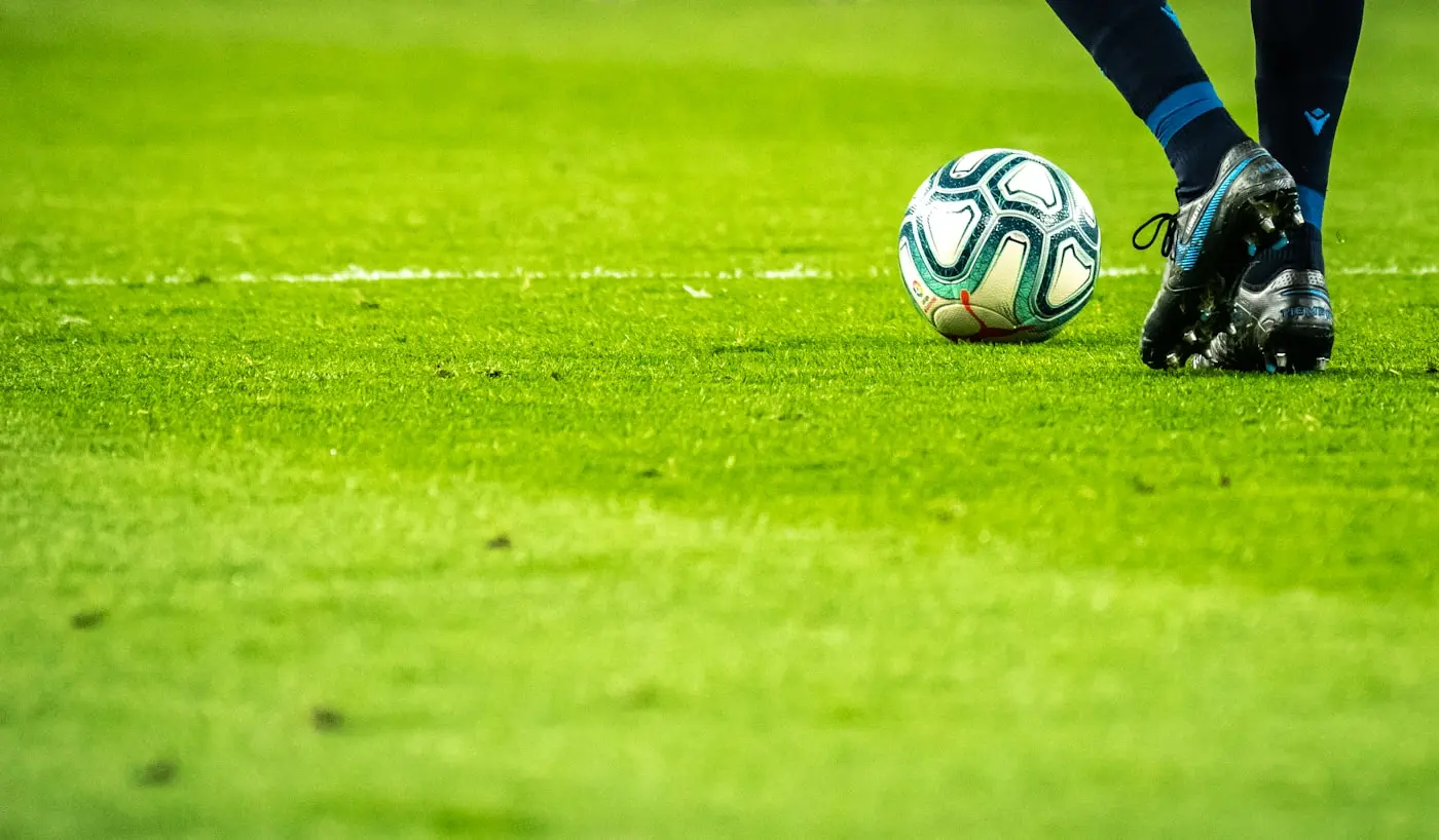 Como ver Sport TV no IPTV Portugal — player, rede e favoritos Bola e chuteiras num campo de futebol